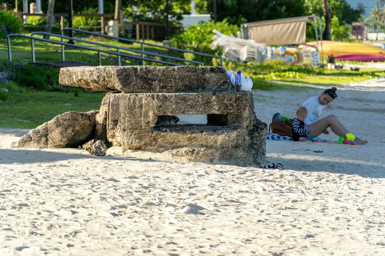 A man sitting on the ground next to a child