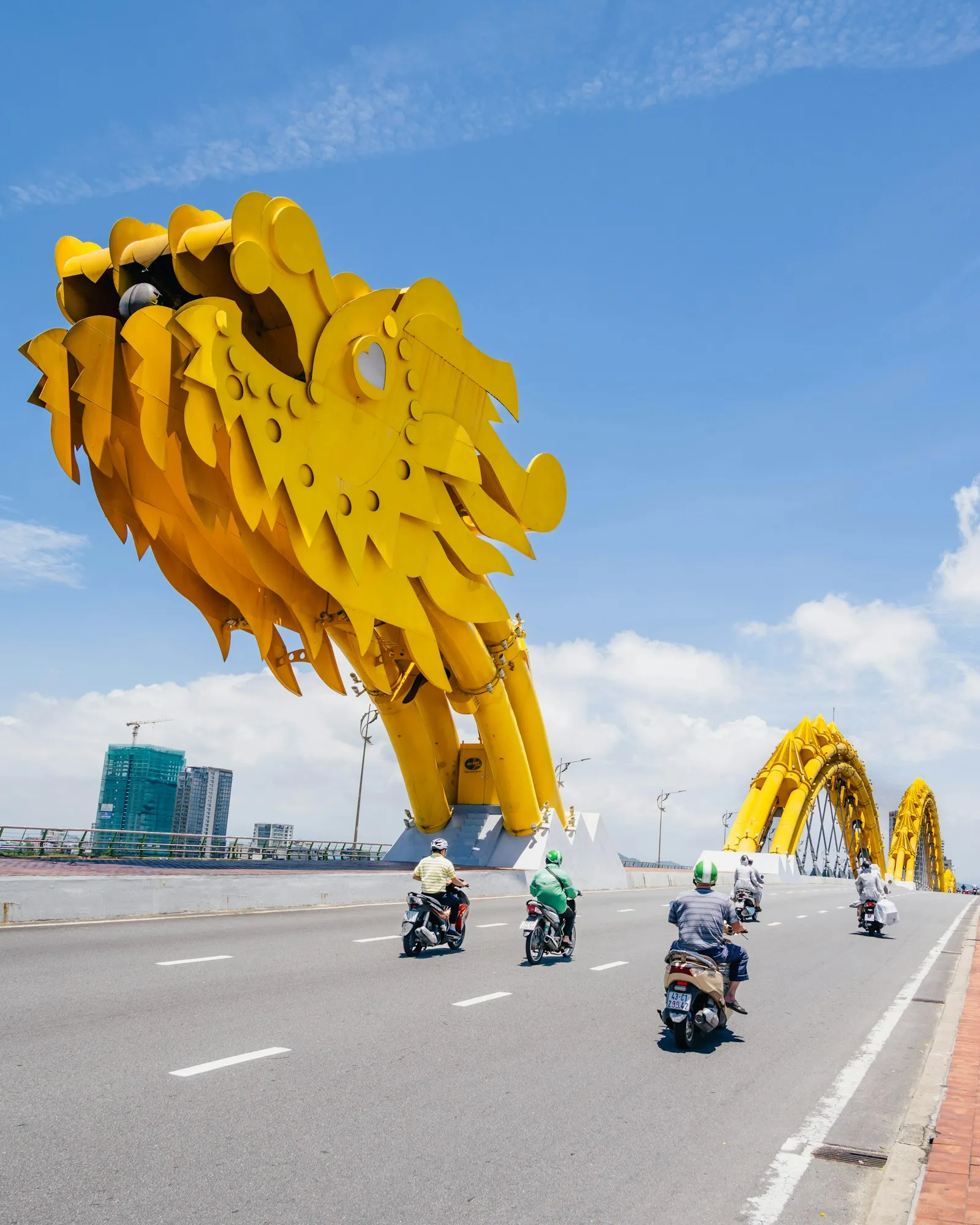 a group of people riding motorcycles down a street