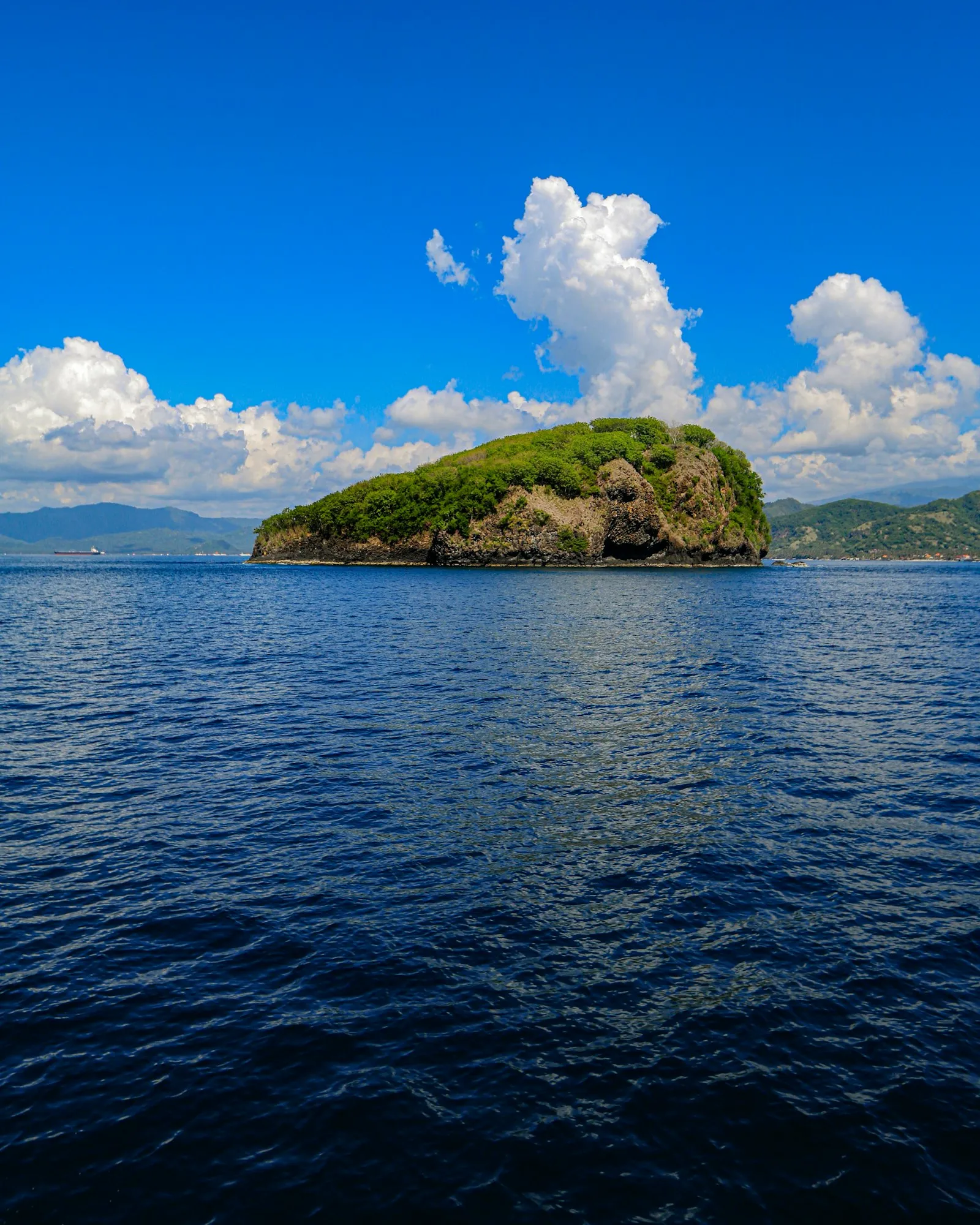 A small island in the middle of a body of water