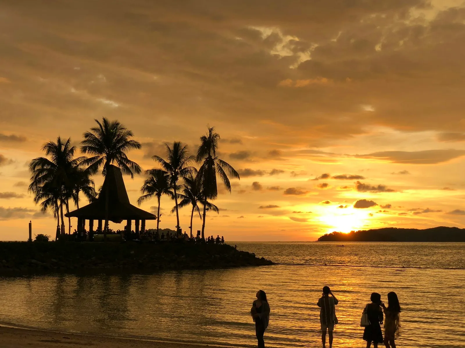 silhouette of people on beach during sunset