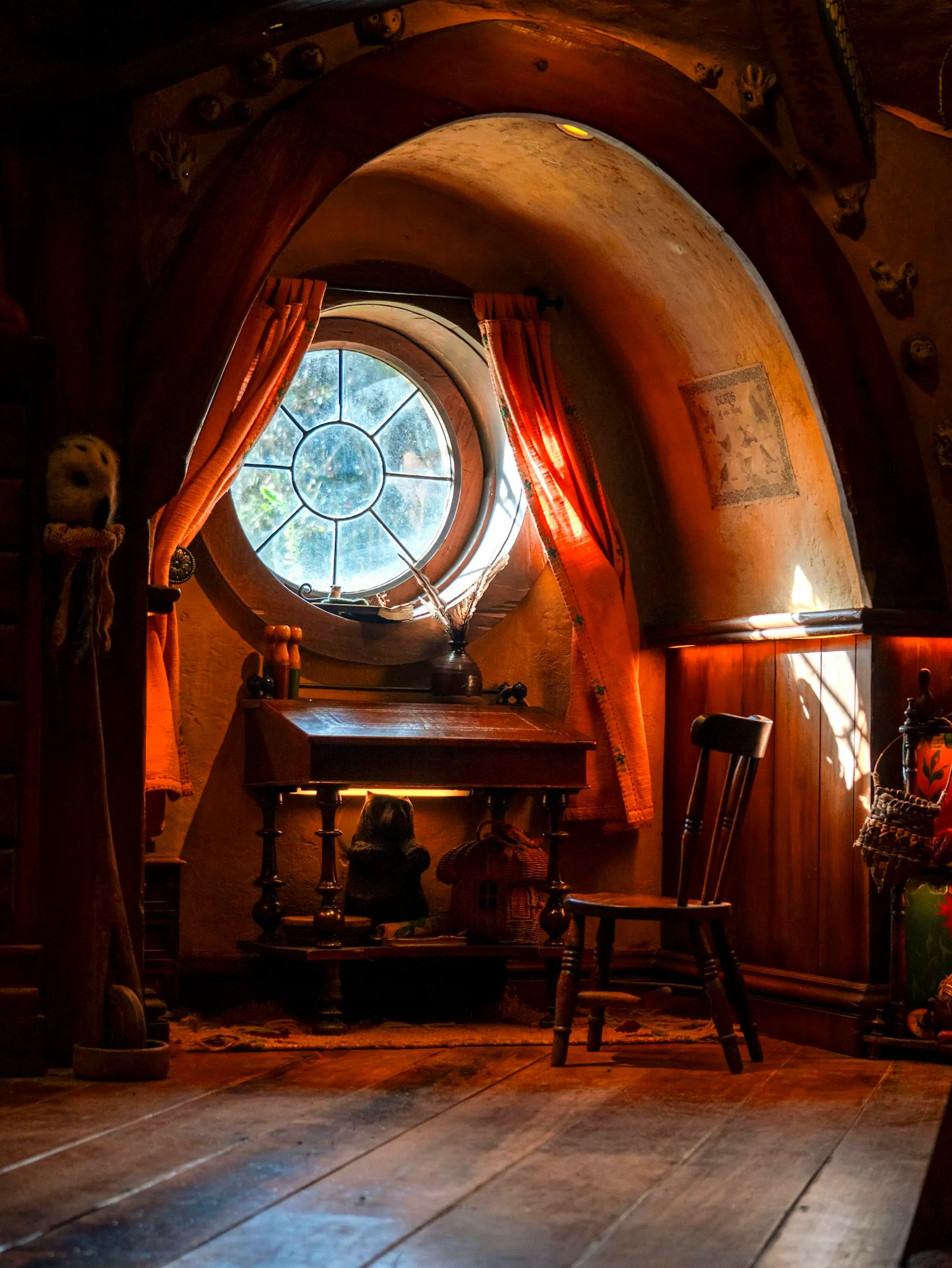 A room with a round window and a wooden floor